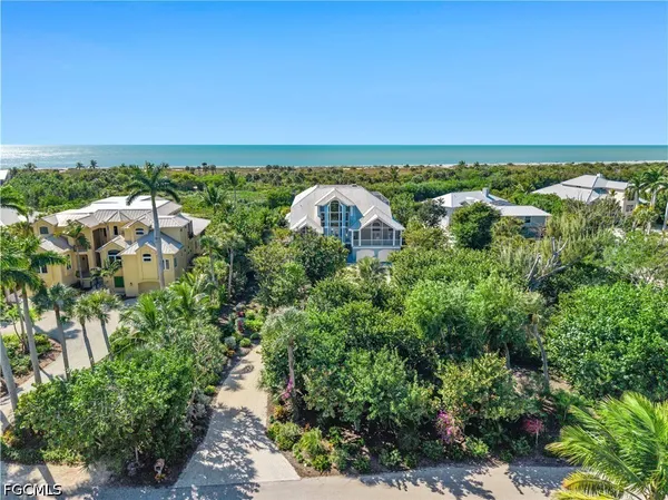 an aerial view of a houses with a lake view