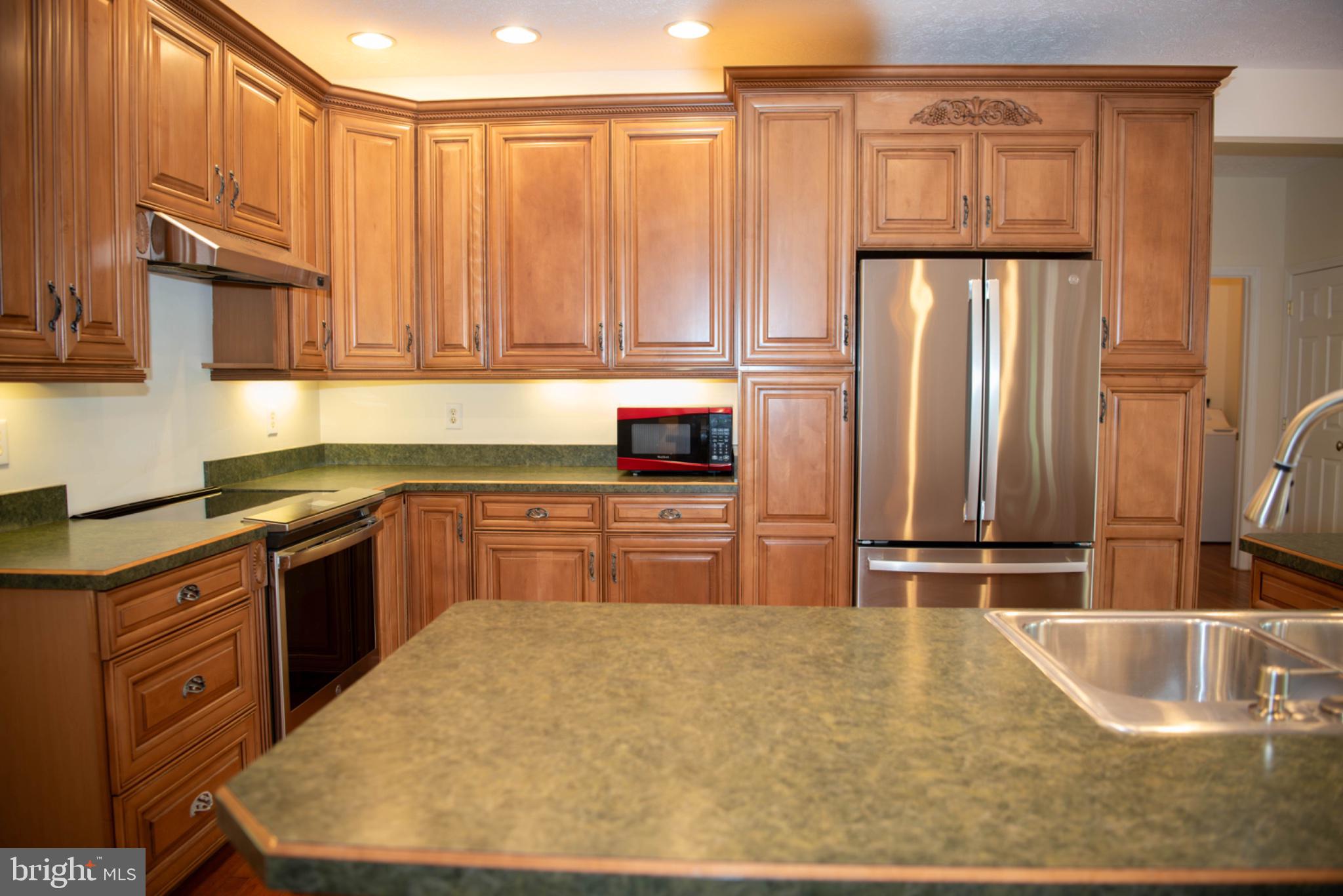 792 Forest Glen Road Moorefield, WV 26836 - Photo 33 of 146 Elegant kitchen with rich wood cabinetry.