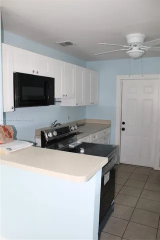 a kitchen with a refrigerator and cabinets