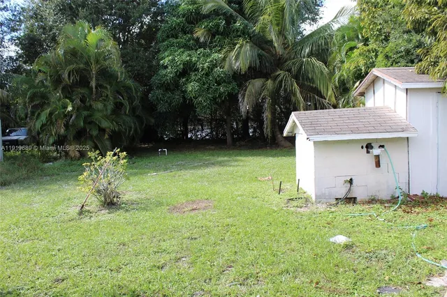 a view of a backyard with plants and a patio