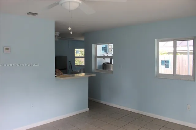wooden floor in a room with a kitchen