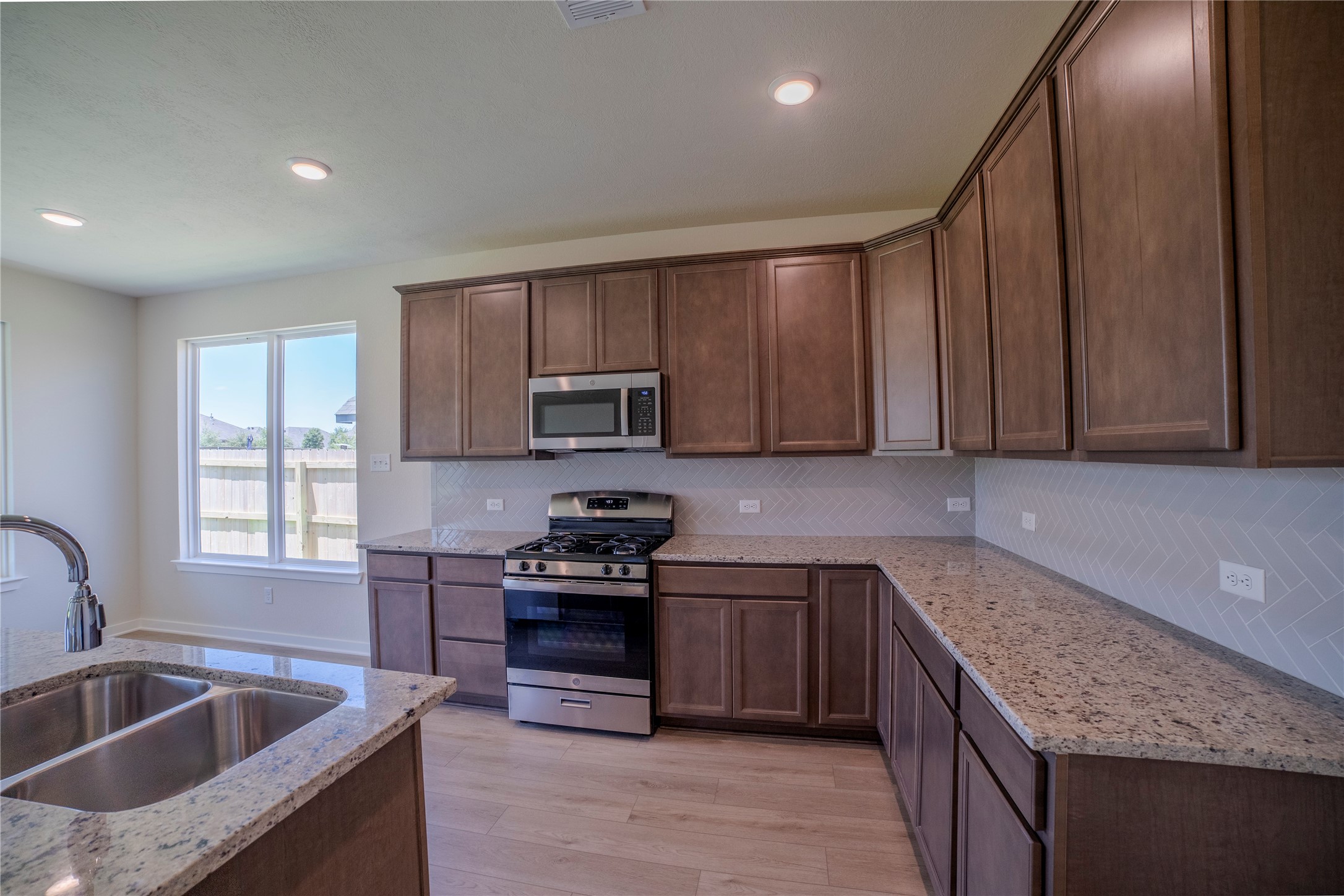 1402 Lk Rdg Drive Brenham, TX 77833 - Photo 20 of 35 a kitchen with stainless steel appliances granite countertop a sink stove and cabinets