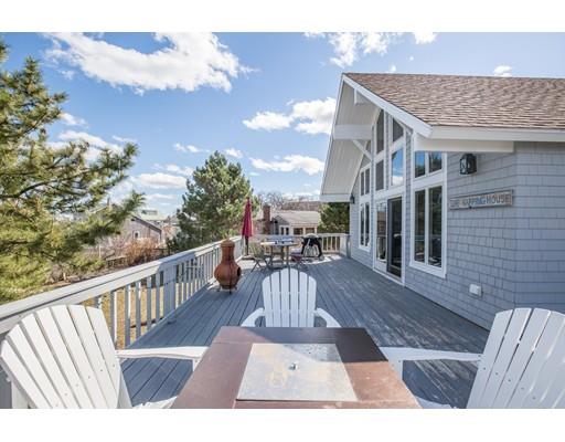 24 Columbia Way Newbury, MA 01951 - Photo 5 of 30 a view of a patio with couches and table and chairs with wooden floor and fence