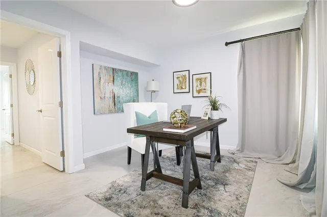 a view of a room that has a table and a chair