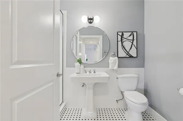 a bathroom with a shower a mirror and a sink