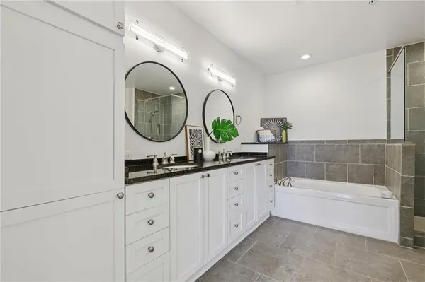 a bathroom with a bathtub and a shower