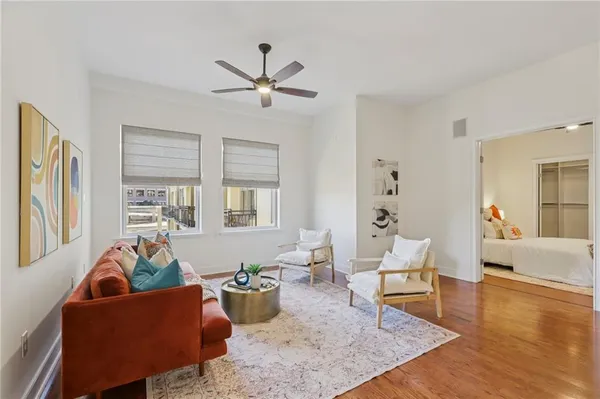 a living room with furniture and a view of kitchen