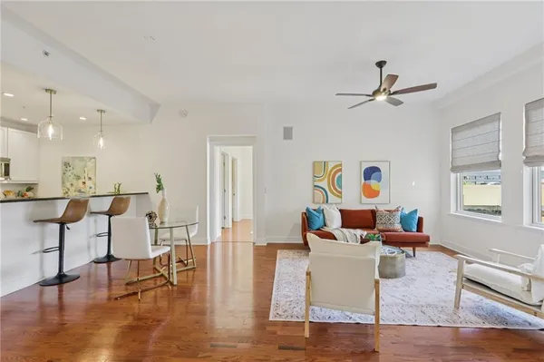 a living room with furniture and wooden floor