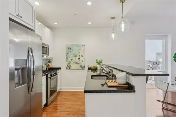 a kitchen with refrigerator and microwave