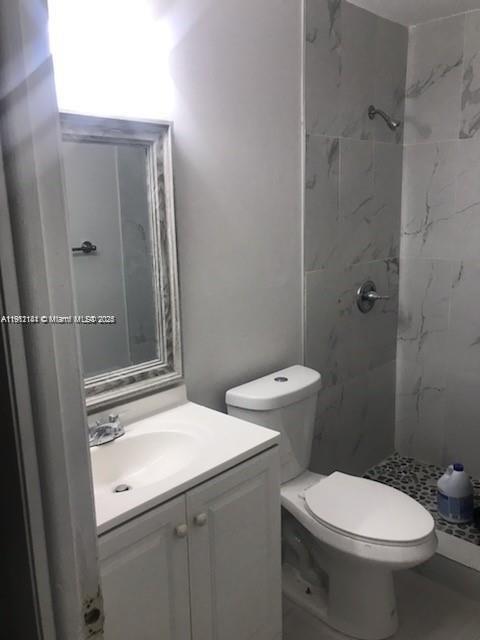4972 Southwest 136th Place, Unit 4972 Miami, FL 33175 - Photo 12 of 24 a bathroom with a sink a toilet and shower