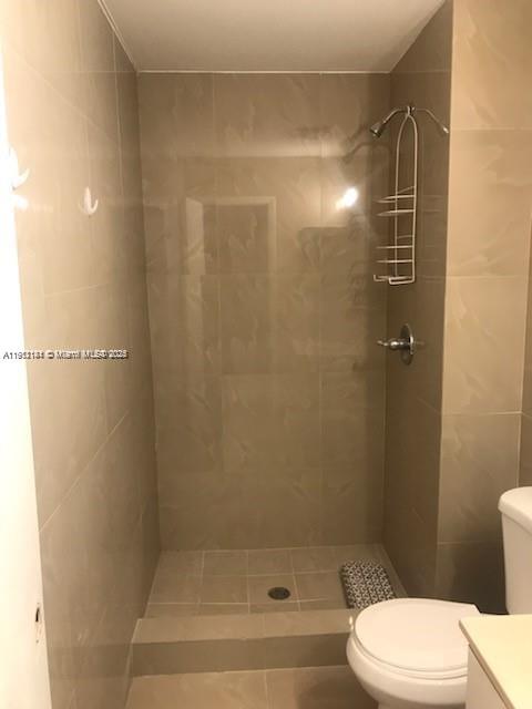 4972 Southwest 136th Place, Unit 4972 Miami, FL 33175 - Photo 13 of 24 a bathroom with a shower and a toilet