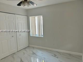 4972 Southwest 136th Place, Unit 4972 Miami, FL 33175 - Photo 16 of 24 an empty room with a chandelier fan
