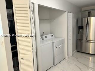 4972 Southwest 136th Place, Unit 4972 Miami, FL 33175 - Photo 19 of 24 a white refrigerator freezer and a stove sitting inside of a kitchen