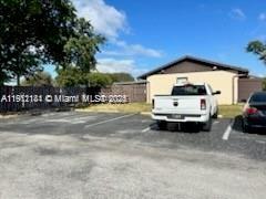 4972 Southwest 136th Place, Unit 4972 Miami, FL 33175 - Photo 24 of 24 a car parked in parking area next to a building