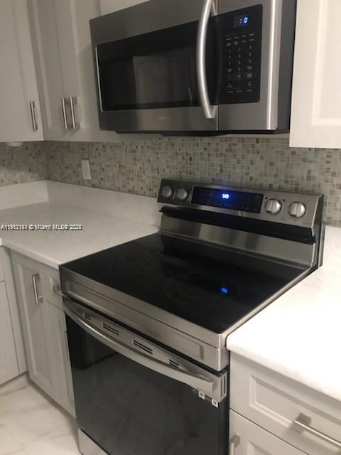 4972 Southwest 136th Place, Unit 4972 Miami, FL 33175 - Photo 9 of 24 a close view of kitchen stove top oven