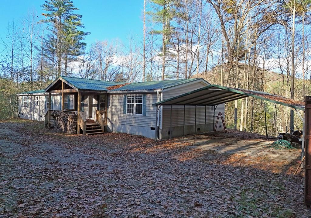 a view of a house with a yard and wooden fence