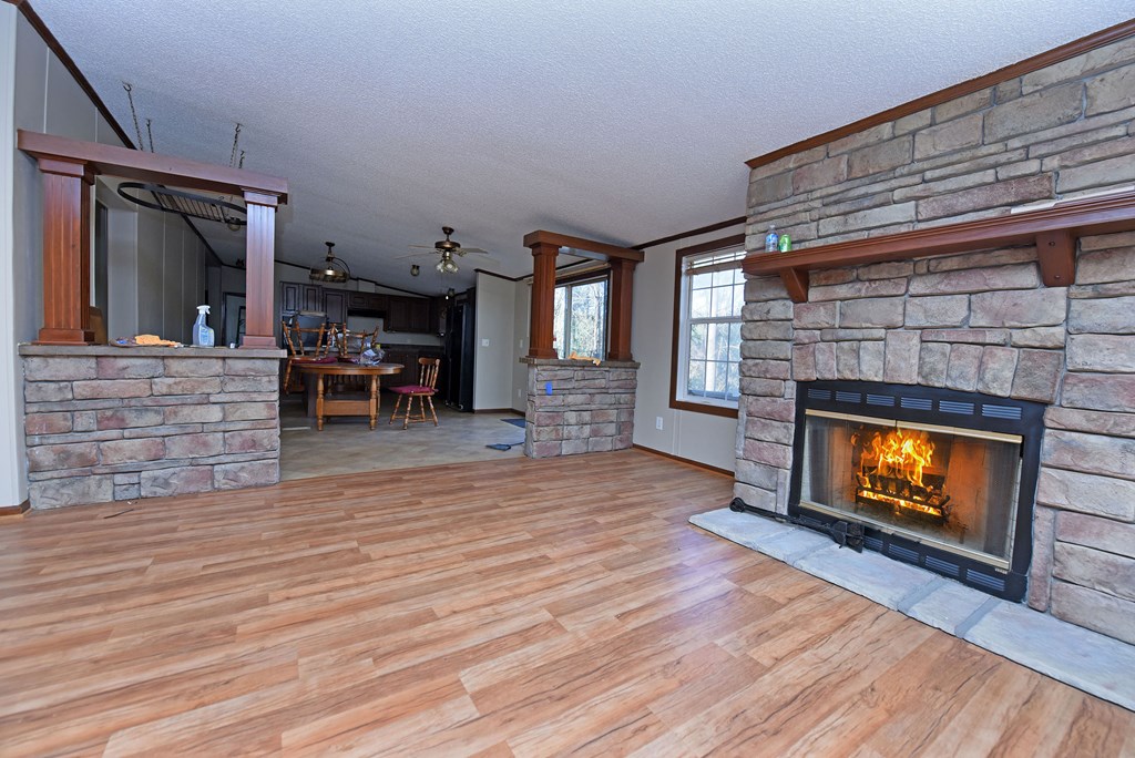 24444 Morganton Highway Blue Ridge, GA 30513 - Photo 15 of 41 a living room with furniture wooden floor and a fireplace