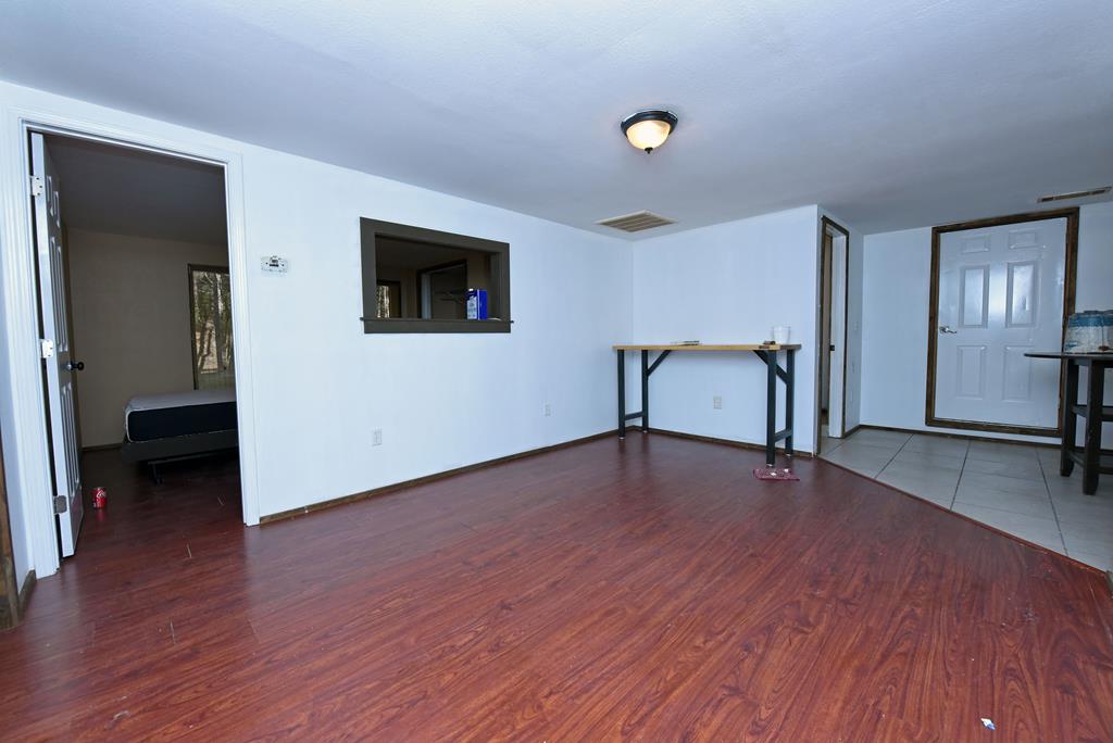 24444 Morganton Highway Blue Ridge, GA 30513 - Photo 38 of 41 a view of an empty room with wooden floor and a window