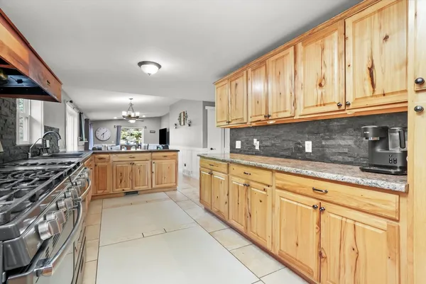 a kitchen with stainless steel appliances granite countertop a sink and cabinets