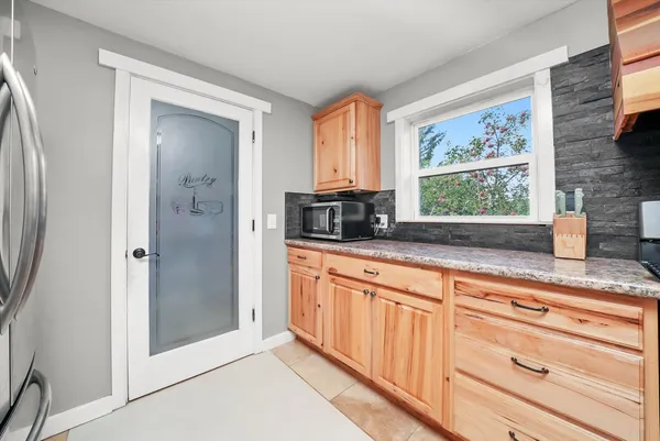 a kitchen with stainless steel appliances granite countertop a refrigerator and a sink