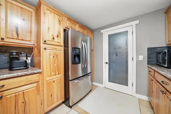 a kitchen with stainless steel appliances granite countertop a refrigerator and a stove top oven