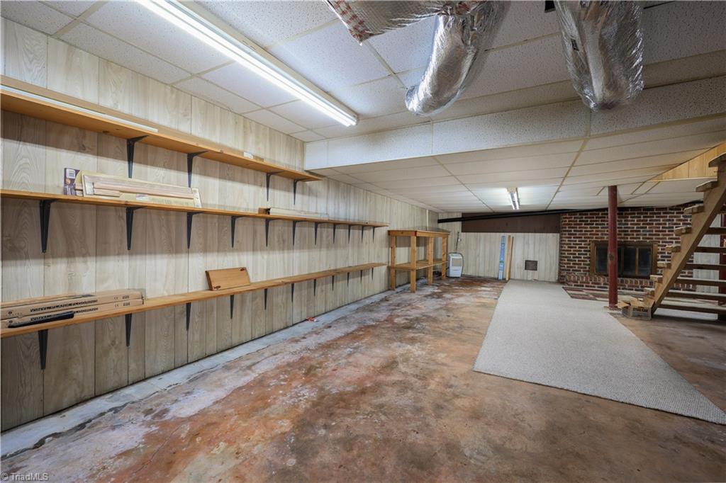 6350 Roscoe Road Denton, NC 27239 - Photo 28 of 50 Basement with french drain and shelving.