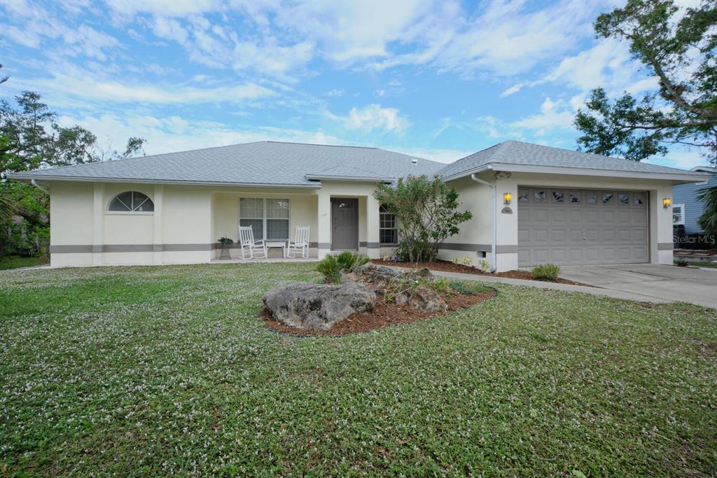 a front view of house with yard and outdoor seating