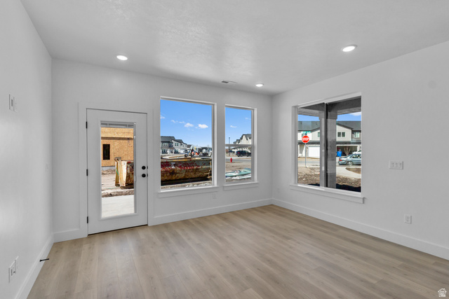 248 West 2920th Street South Logan, UT 84321 - Photo 9 of 47 Recessed lighting, wood-finish flooring, white trim, multiple windows, and a glass-paneled door