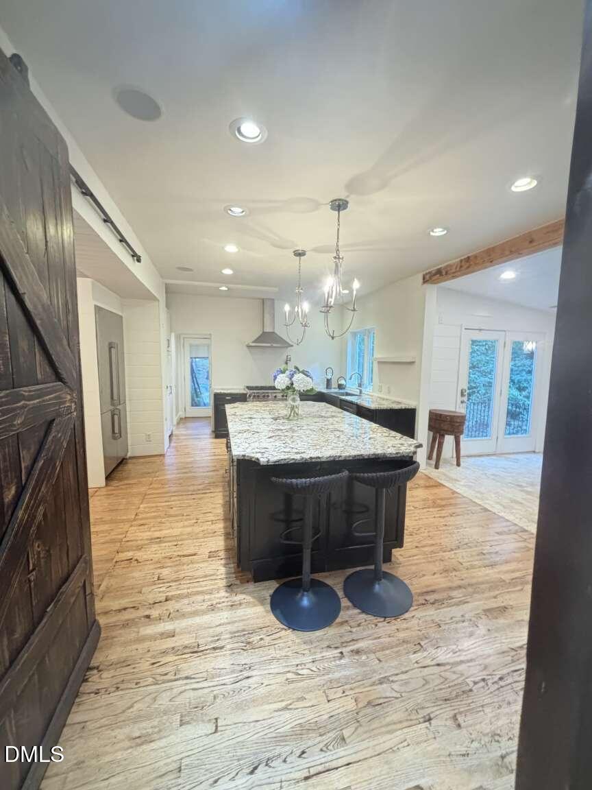1204 Queensferry Road Cary, NC 27511 - Photo 13 of 50 a large kitchen with a large counter top a sink stainless steel appliances and cabinets