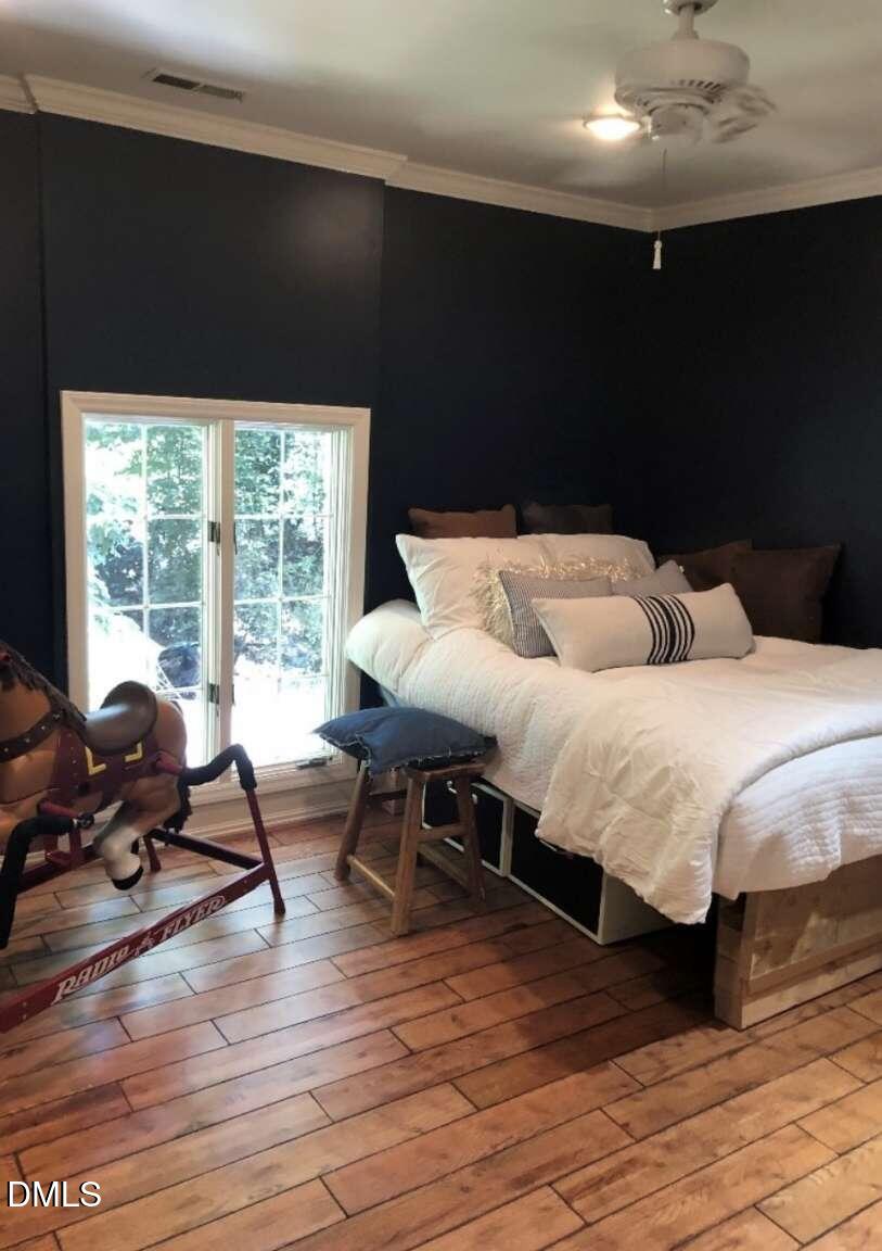 1204 Queensferry Road Cary, NC 27511 - Photo 23 of 50 a bedroom with a bed and large windows