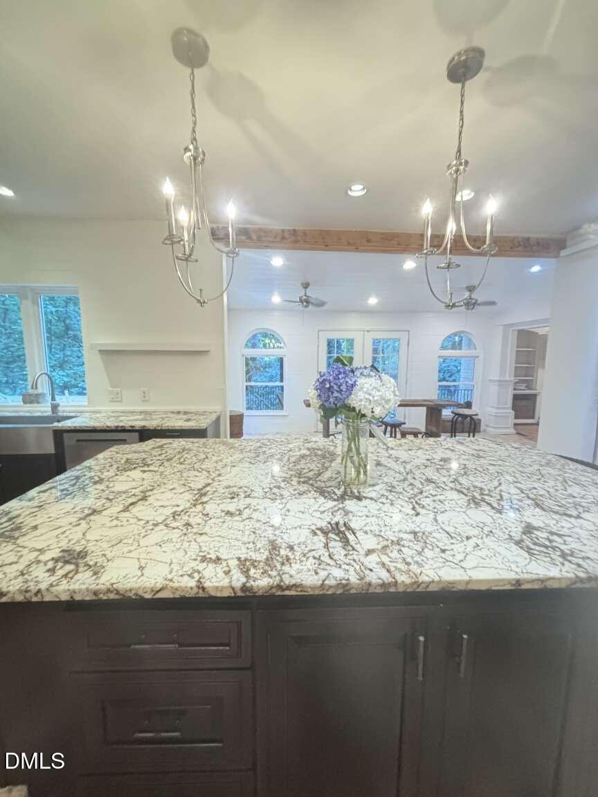 1204 Queensferry Road Cary, NC 27511 - Photo 30 of 50 a view of a kitchen with kitchen island a sink wooden floor and a chandelier
