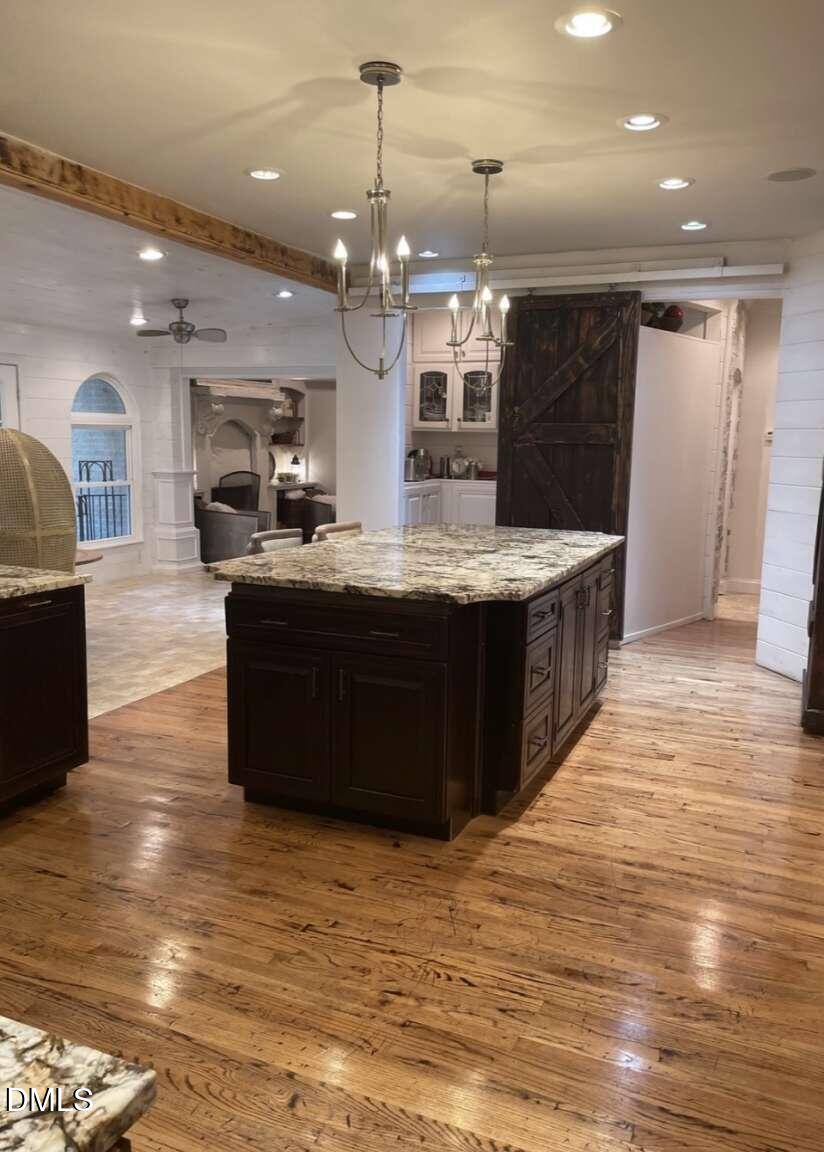 1204 Queensferry Road Cary, NC 27511 - Photo 31 of 50 a large kitchen with stainless steel appliances granite countertop a large counter top a stove and a wooden floors