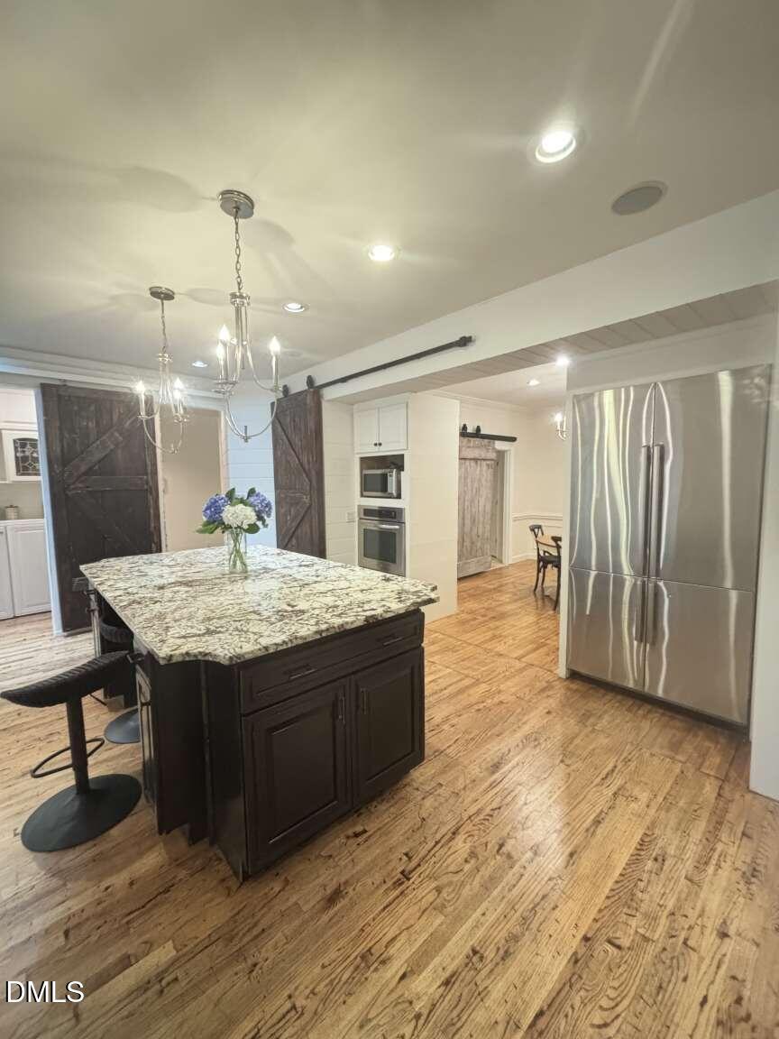 1204 Queensferry Road Cary, NC 27511 - Photo 36 of 50 a bathroom with a sink a vanity and a large mirror