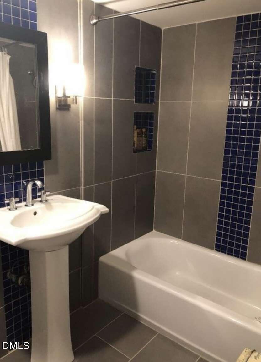 1204 Queensferry Road Cary, NC 27511 - Photo 45 of 50 a bathroom with a sink and a mirror