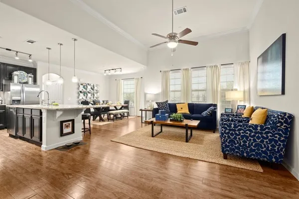 a living room with furniture a rug and white walls