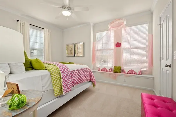 a living room with a bed furniture and a large window