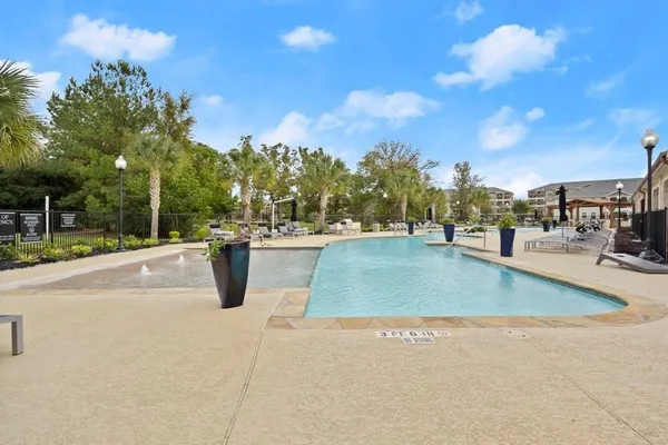 a view of a swimming pool with an outdoor seating