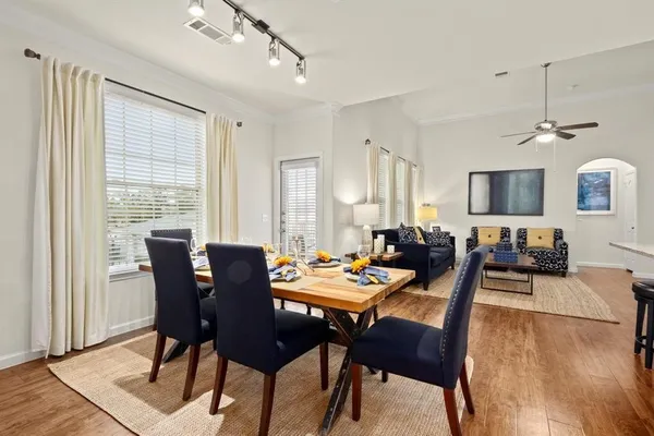 a view of a dining room with furniture and wooden floor
