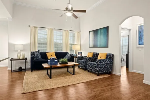 a living room with furniture and wooden floor