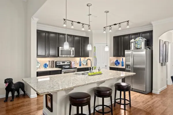 a kitchen with granite countertop cabinets and stainless steel appliances
