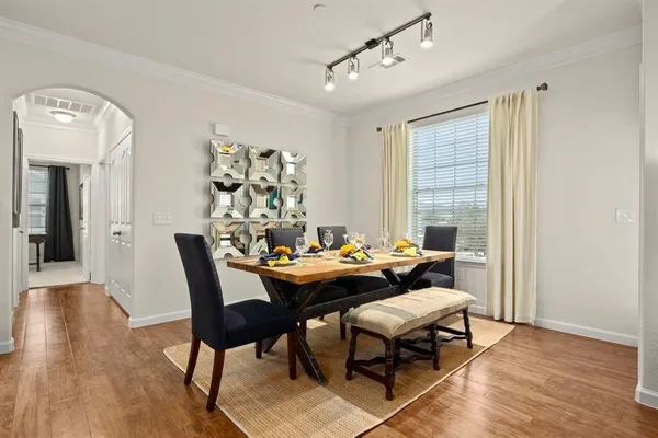 a dining room with furniture and wooden floor