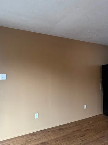 a view of an empty room and wooden floor