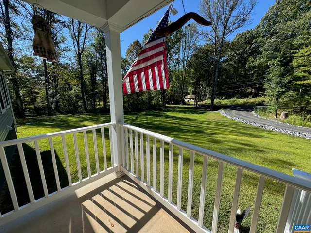 a view of a chairs and table in the balcony