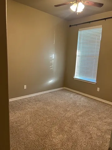 an empty room with a empty space and a window