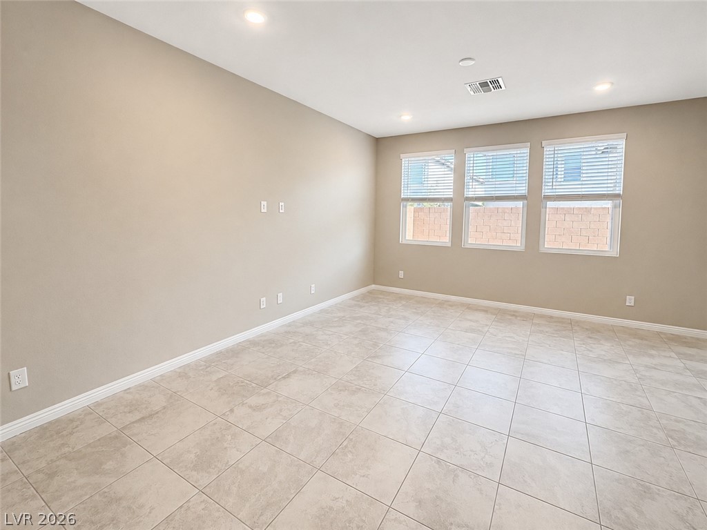 8768 Rio Andir Avenue Las Vegas, NV 89148 - Photo 2 of 9 A versatile living space with light-colored tile flooring and multiple windows for abundant natural illumination.