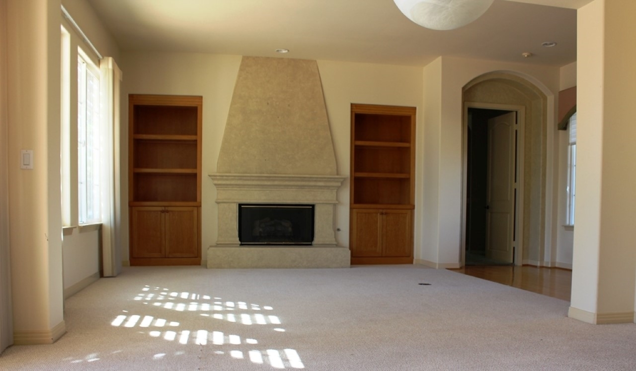 13635 Overland Pass Road Poway, CA 92064 - Photo 15 of 25 Magestic fireplace with built-in cabinets that have lighting installed.