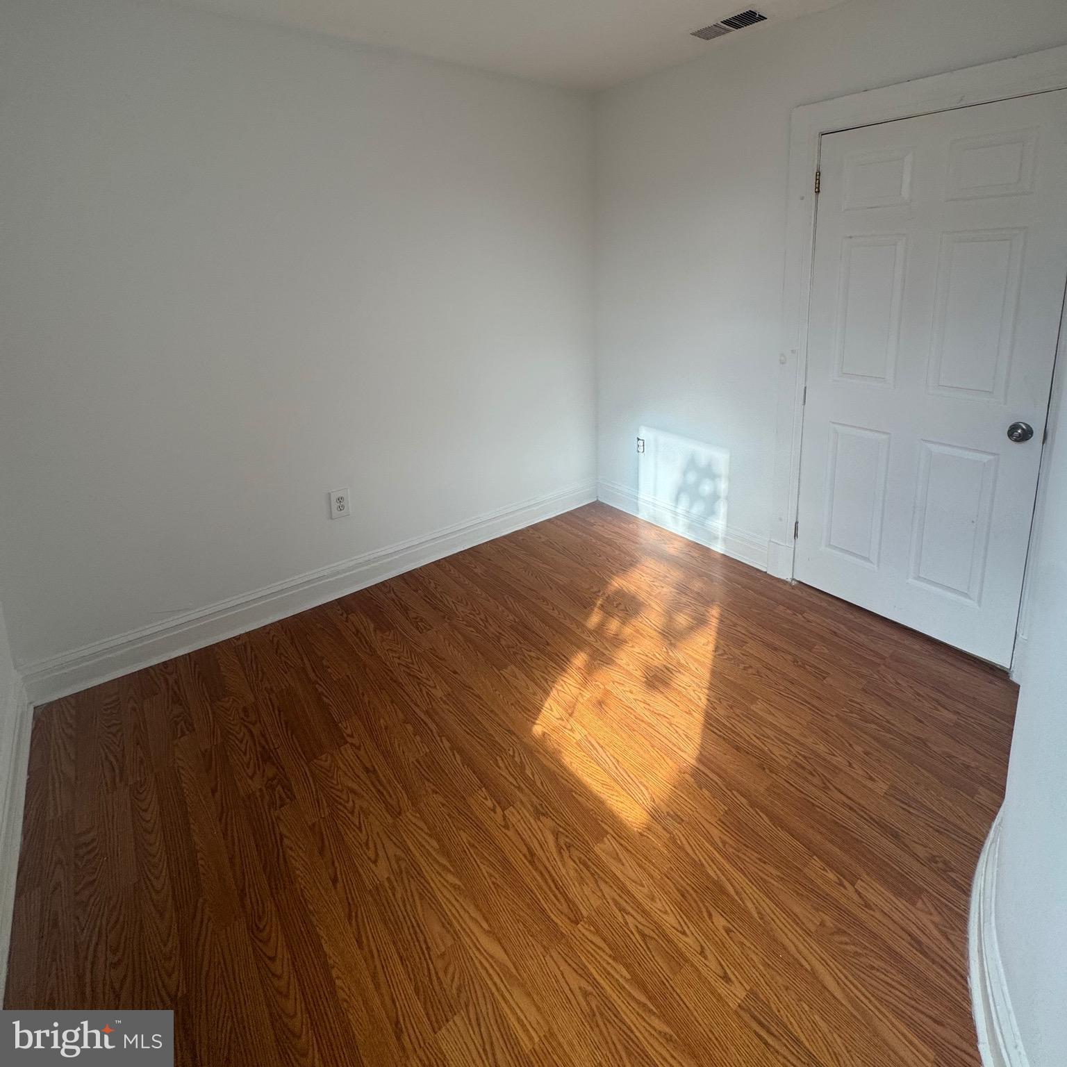 31 South Arlington Avenue Baltimore, MD 21223 - Photo 7 of 10 a view of empty room with wooden floor