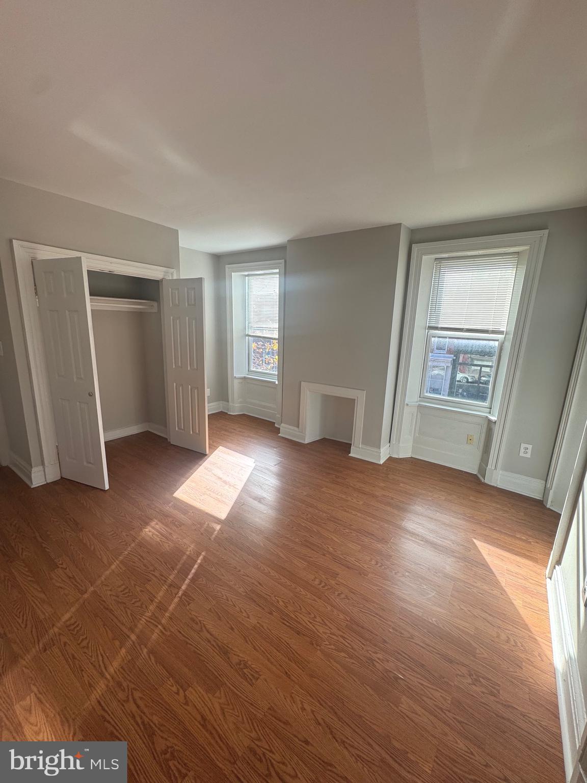 31 South Arlington Avenue Baltimore, MD 21223 - Photo 10 of 10 an empty room with wooden floor and windows