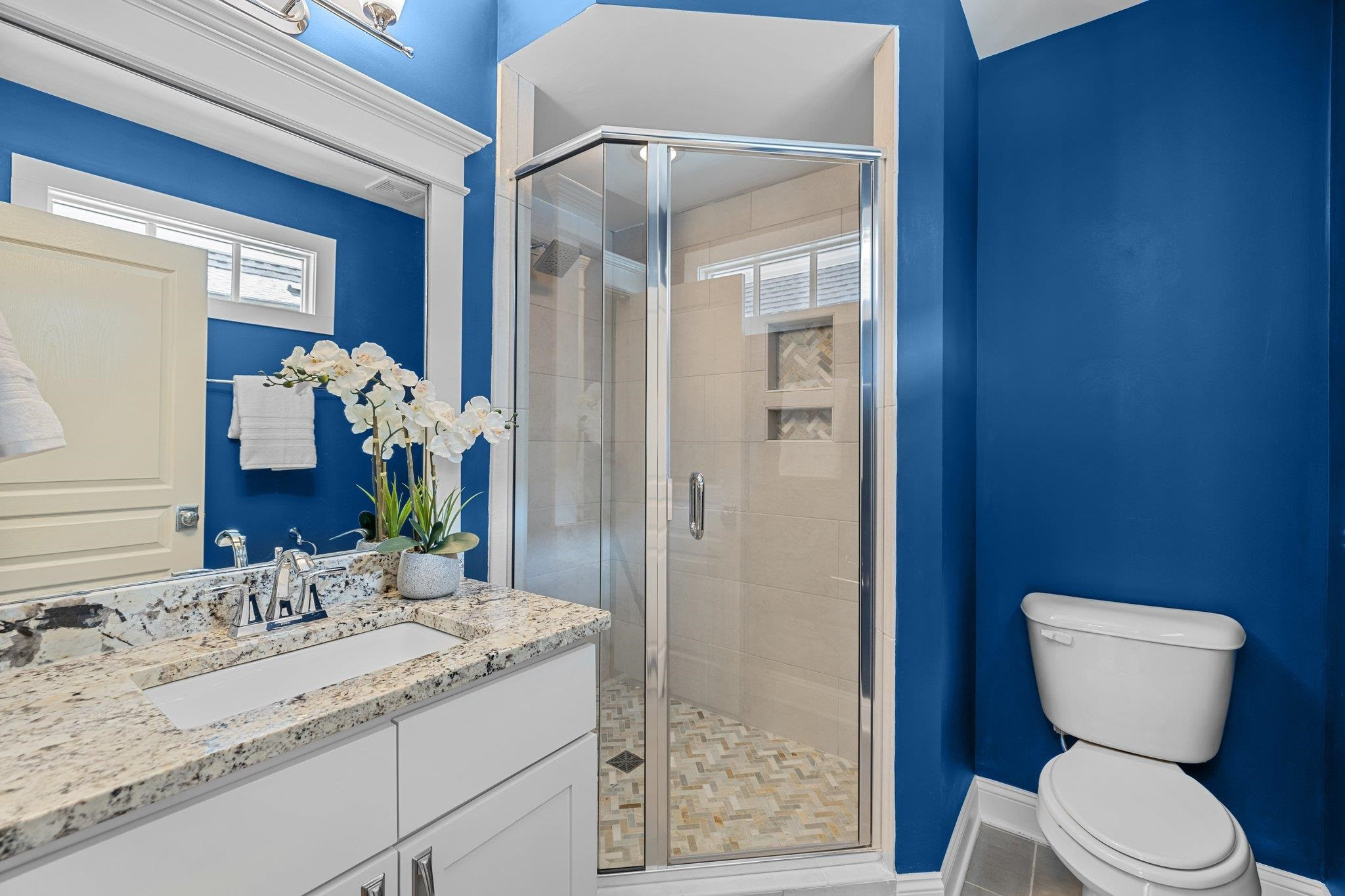 2116 Cowper Drive Raleigh, NC 27608 - Photo 50 of 65 This full bathroom off of the second bedroom is a major upgrade to the guest room. It has a walk in shower and a nicely updated vanity. En-Suite Bathroom