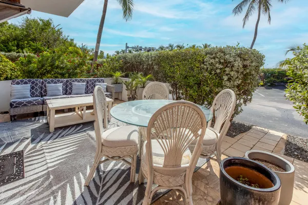 a view of a chairs and table in a backyard